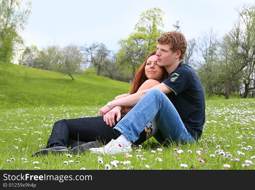 Happy young couple relaxing outdoors. Happy young couple relaxing outdoors