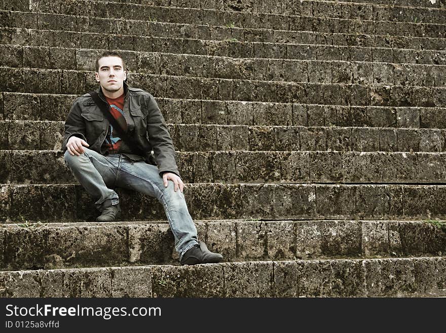 Young guy sitting on stairs