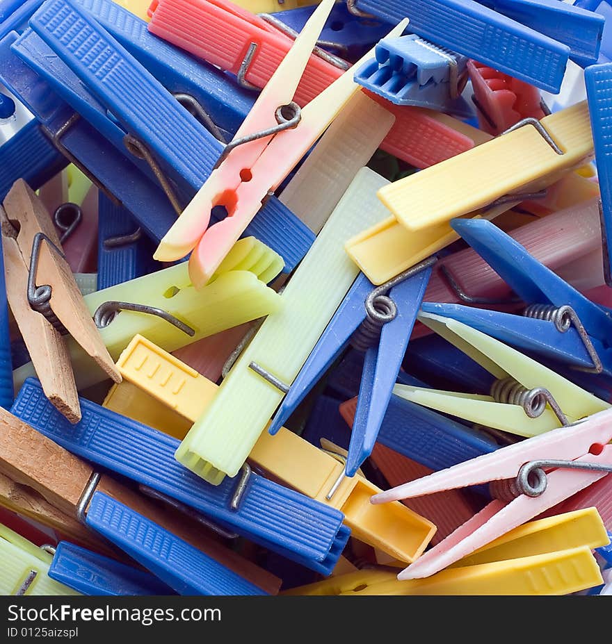 A pile of clothespins of different shape and colors