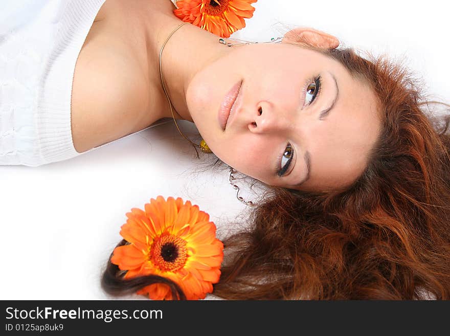 Beautiful young girl with flowers is relaxing. Beautiful young girl with flowers is relaxing