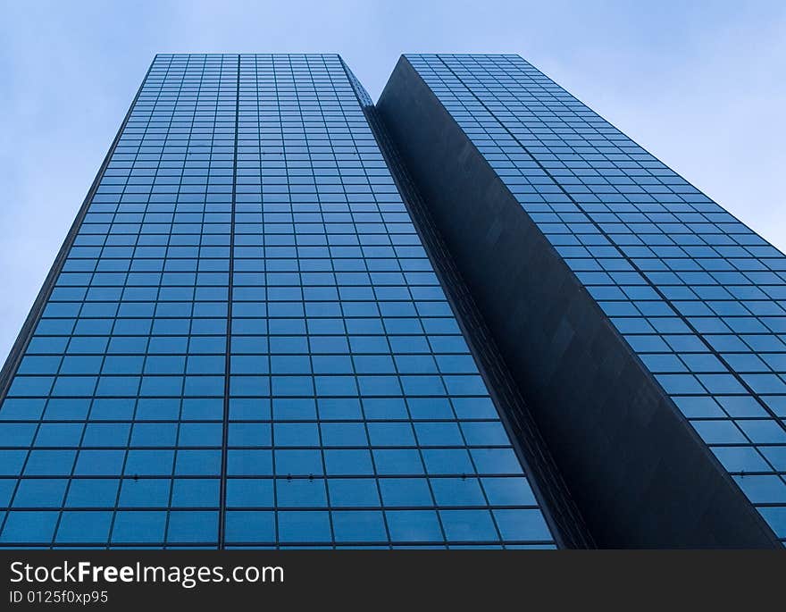 Mirrored skyscraper against blue sky in Boston