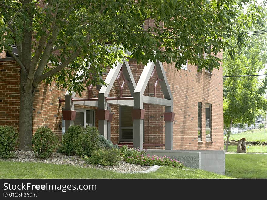 An triangular eave hangs above a doorway. An triangular eave hangs above a doorway.