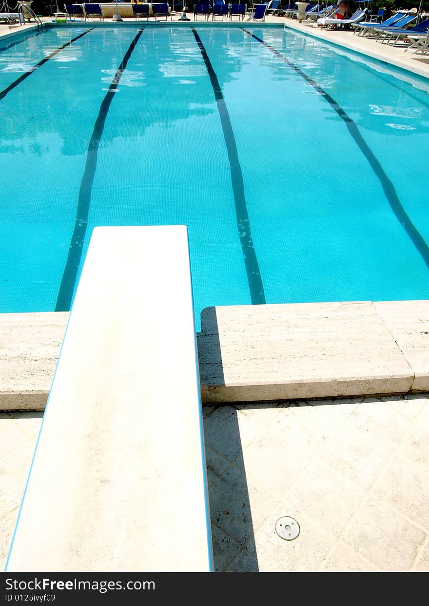 A good shot of a pool with diving board. A good shot of a pool with diving board