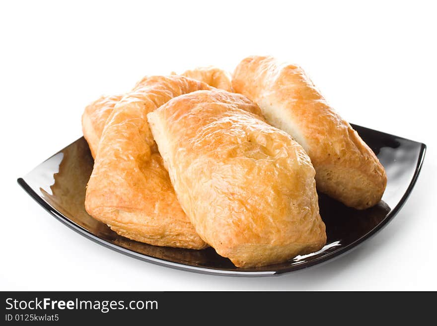 Fresh rolls on a plate on a white background