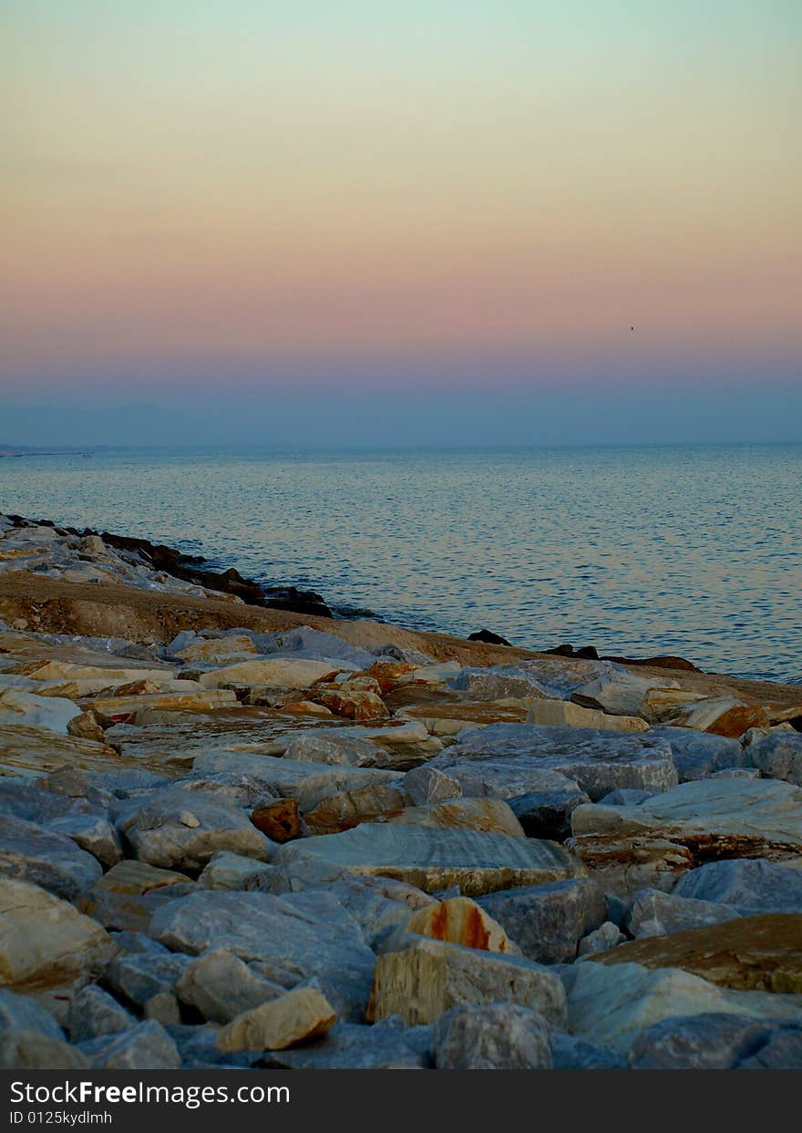 A suggestive shot of rocks and sea at the sunset hour