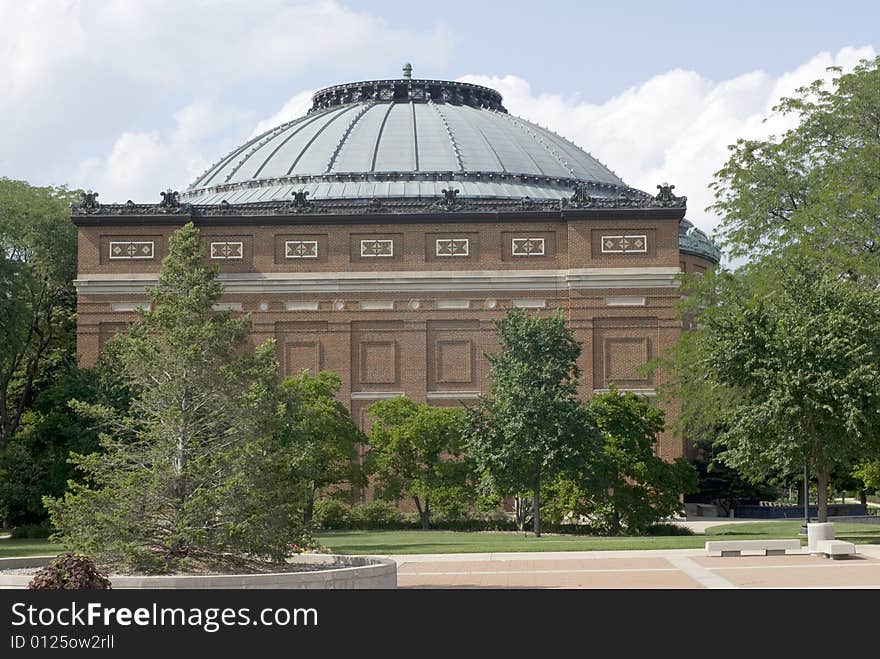 An ornate brick building in a park. An ornate brick building in a park.