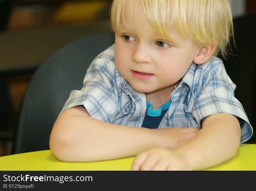 Small boy at the desk in restaurant. Small boy at the desk in restaurant