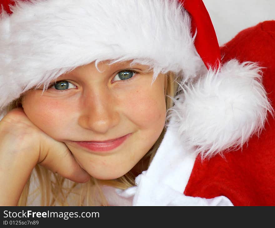 An adorable girl is  wearing a santa dress. An adorable girl is  wearing a santa dress.