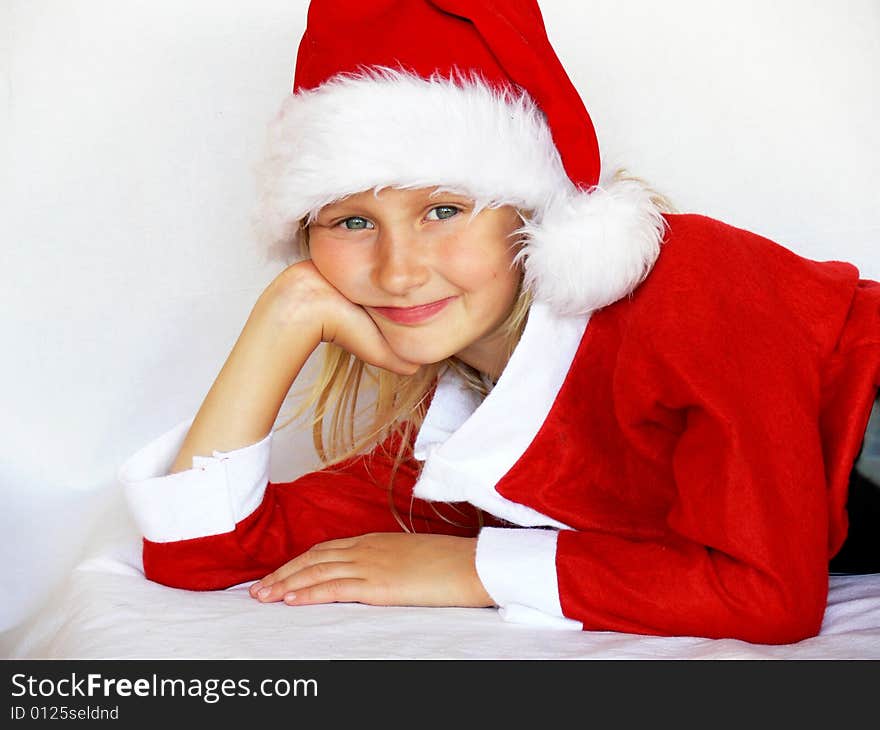 An adorable girl is  wearing a santa dress. An adorable girl is  wearing a santa dress.