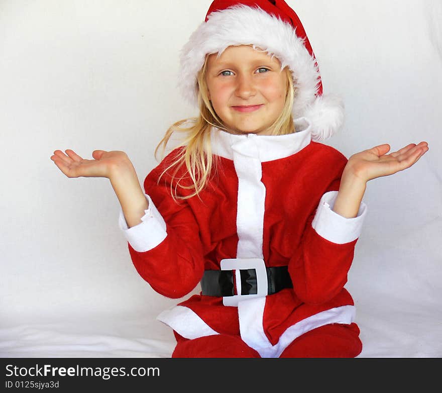 An adorable girl is  wearing a santa dress. An adorable girl is  wearing a santa dress.