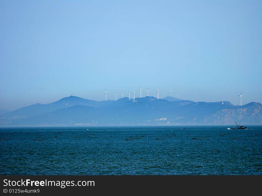 An island with wind turbines, penglai, shandong, china