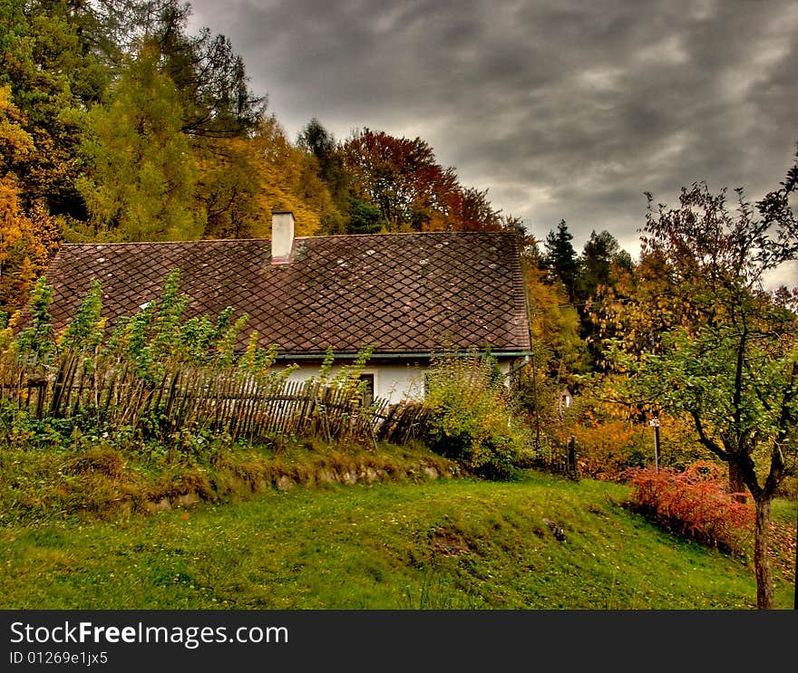 Cottage In Autumn With Dark Sky