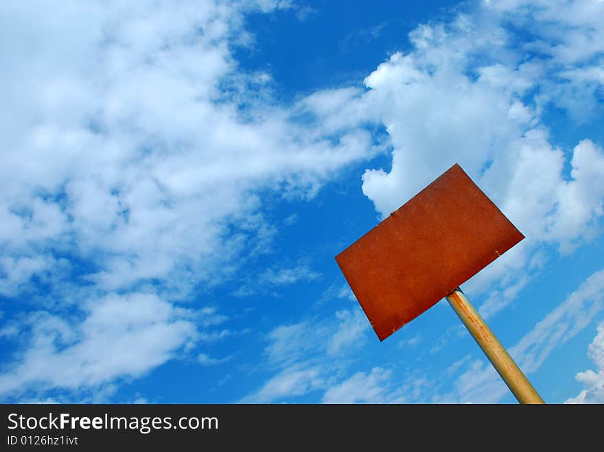 Rusty sign against blue sky