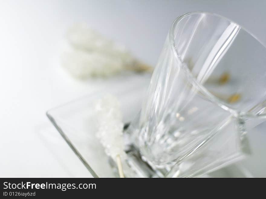 Empty glass cup, plate and caramel sugar