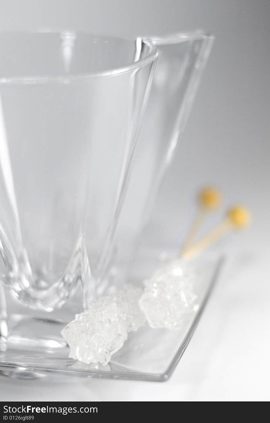 Empty glass cup, plate and caramel sugar