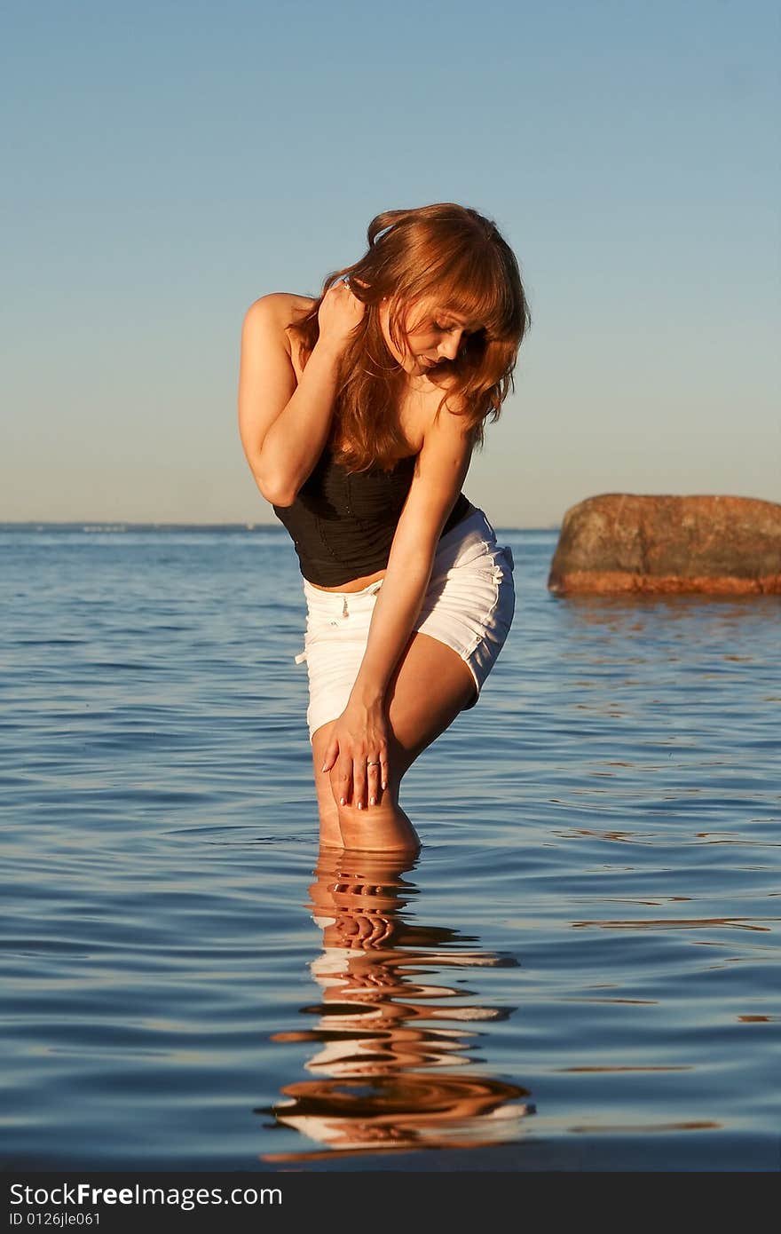 Dreamy young woman in blue water