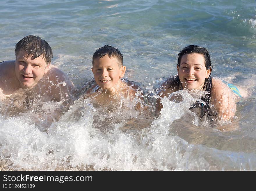 Woman, man and boy on the beach