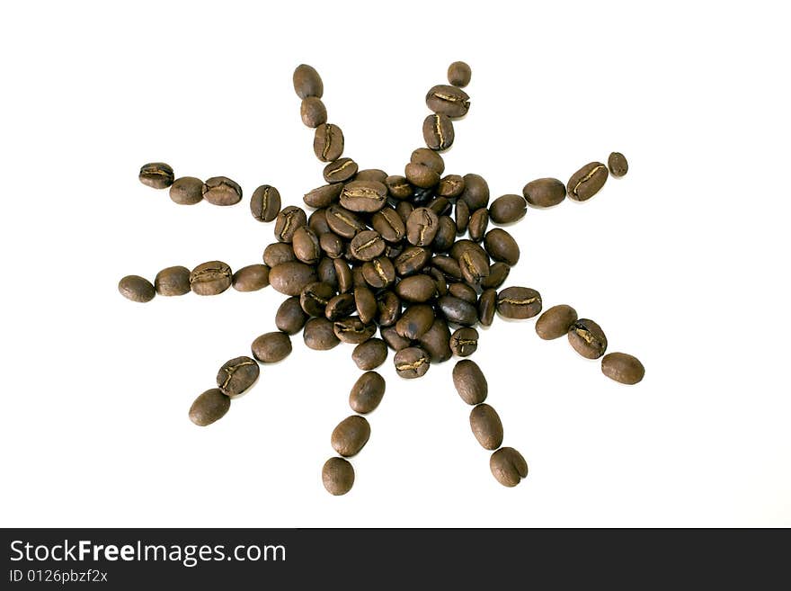 Coffee beans in sun shape on white background. Coffee beans in sun shape on white background