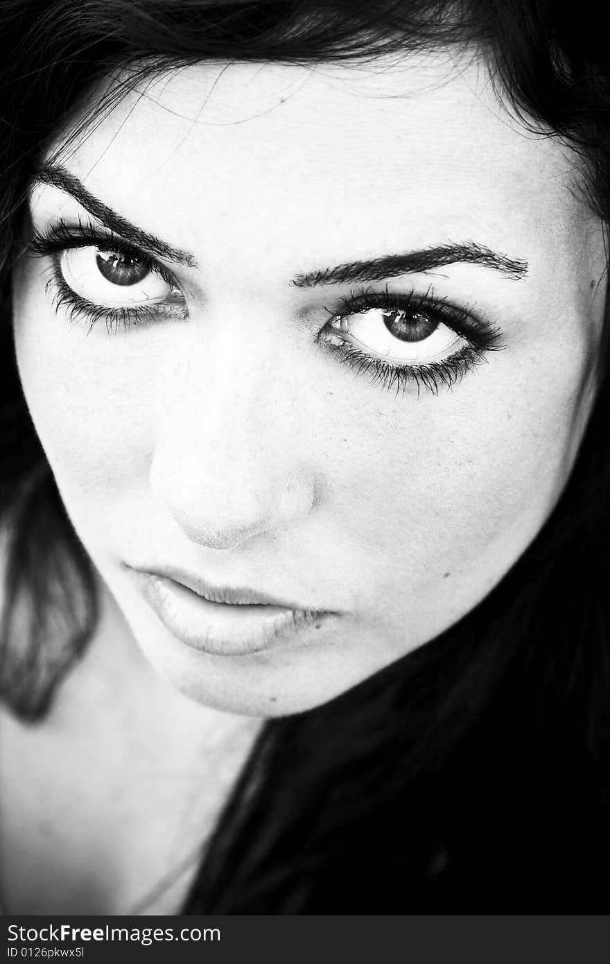 Young staring woman in contrasted black and white.