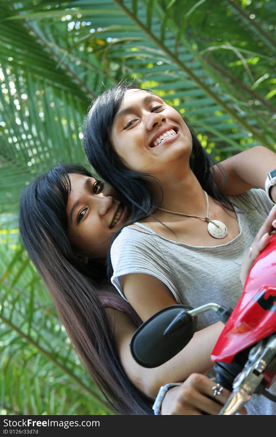 Two girl having fun on motorcycle in nature. Two girl having fun on motorcycle in nature