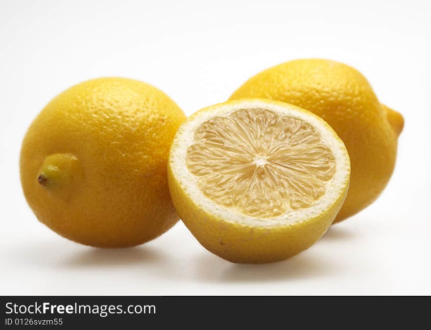 Three lemons citrus isolated fruit yellow half