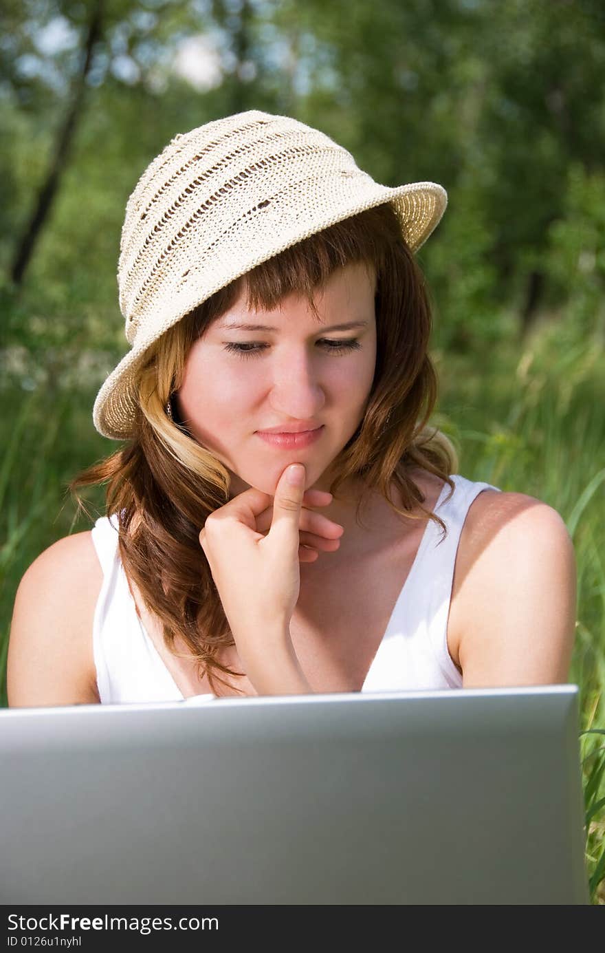 Thoughtful pretty girl with a notebook in the park. Thoughtful pretty girl with a notebook in the park