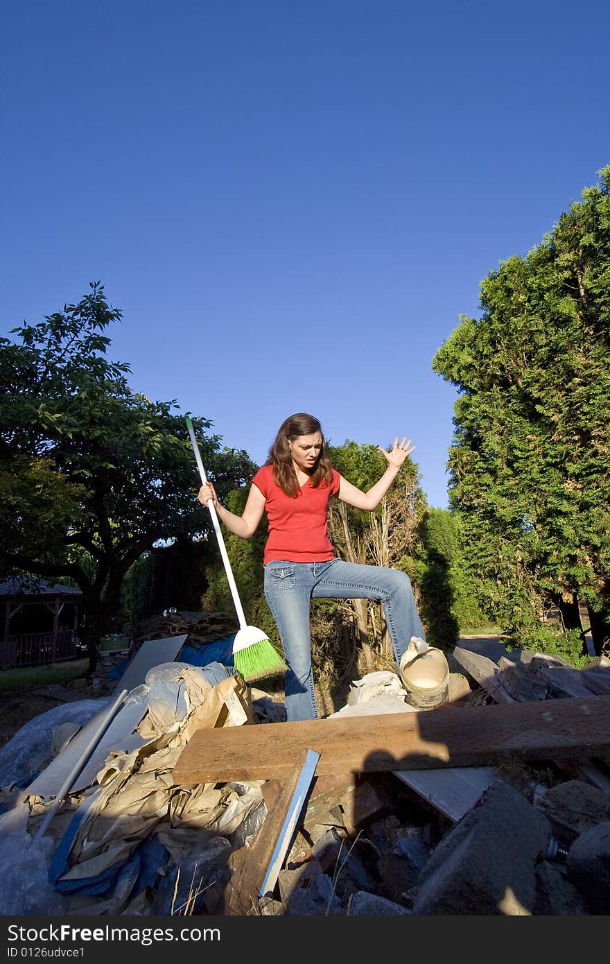 Woman Sweeping Through Garbage - Vertical