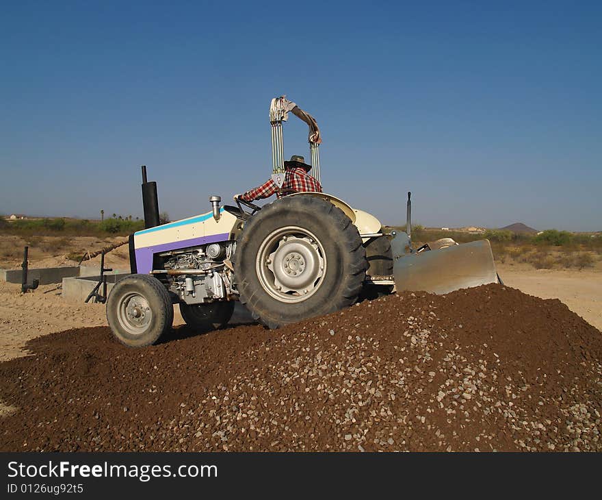 Man On Tractor Pushing Dirt - Horizontal