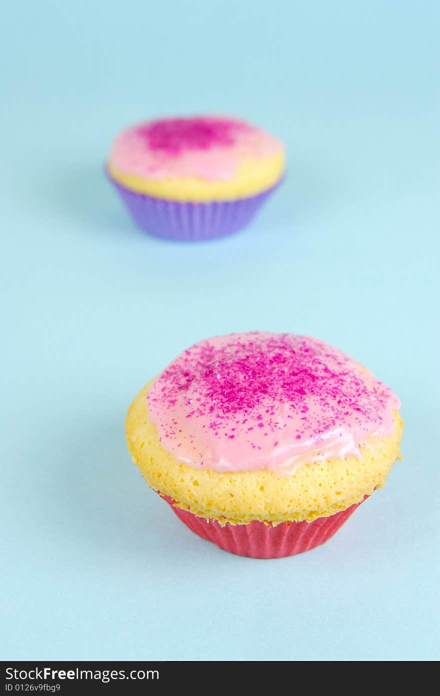 Cup cakes isolated against a blue background