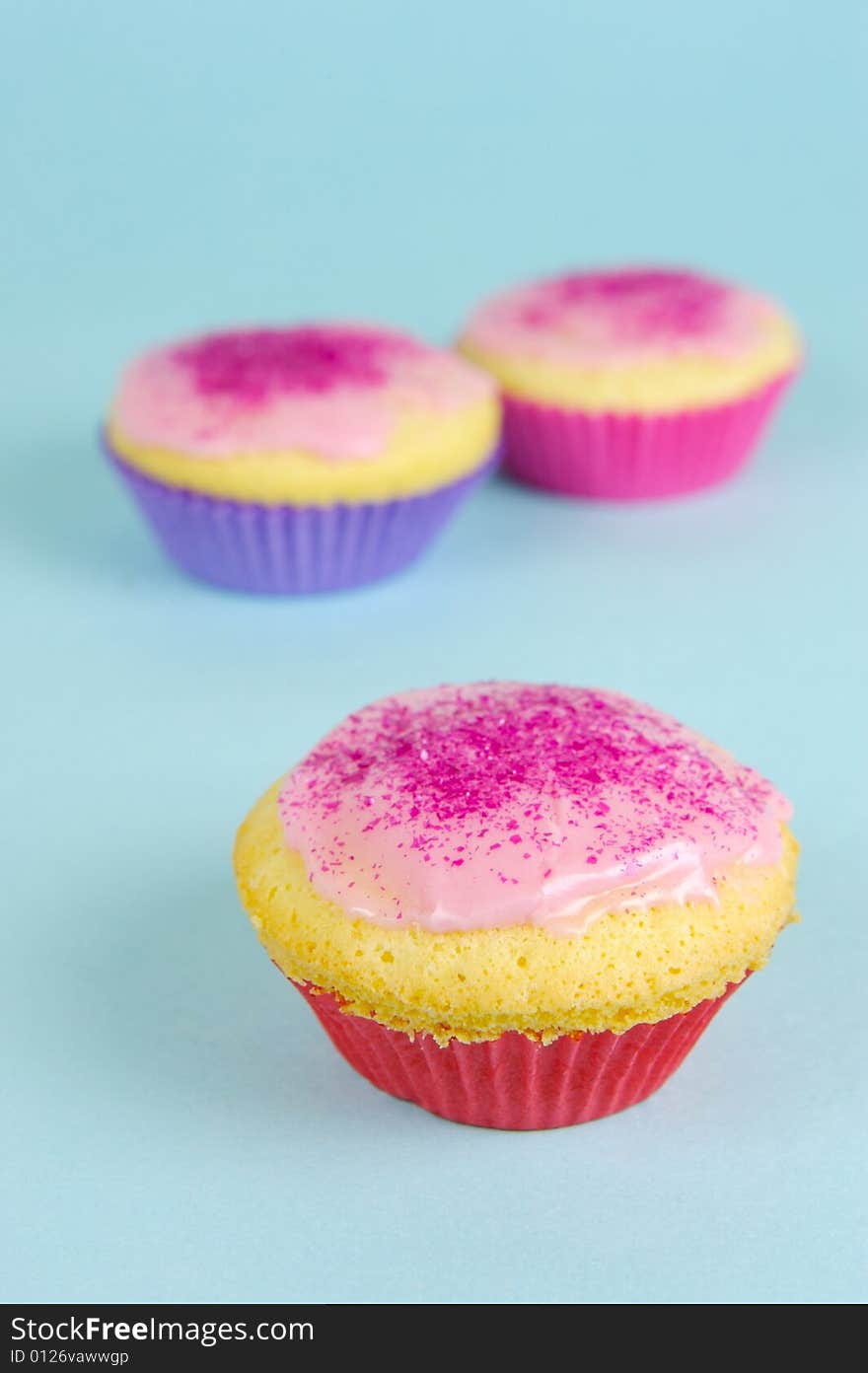 Cup cakes isolated against a blue background