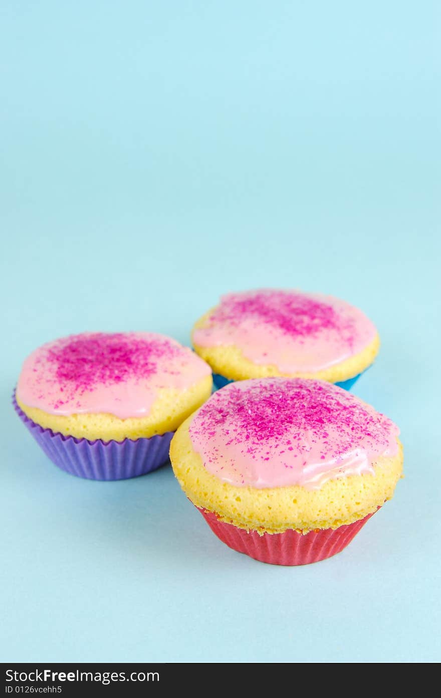 Cup cakes isolated against a blue background