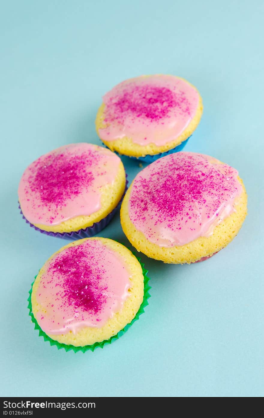 Cup cakes isolated against a blue background