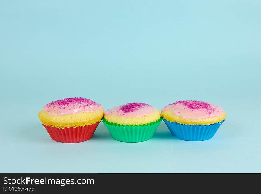 Cup cakes isolated against a blue background