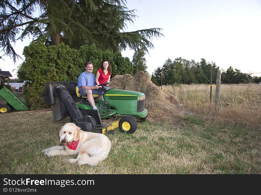 Man, Woman, and Dog on a Tractor - Horizontal