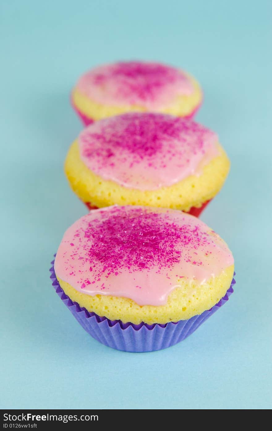 Cup cakes isolated against a blue background