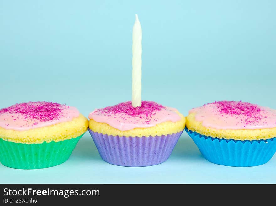 Cup cakes isolated against a blue background