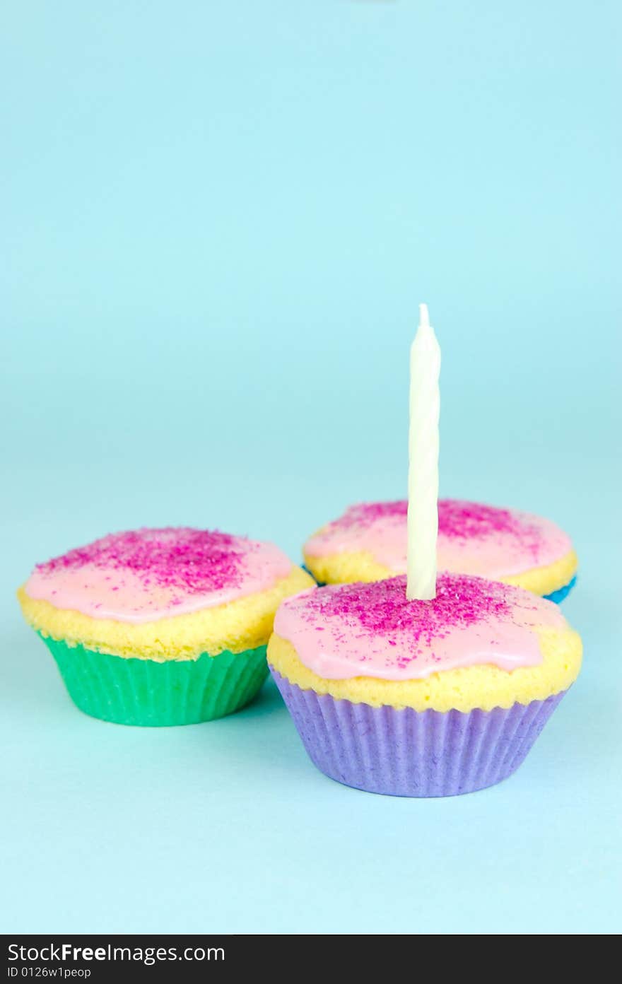 Cup cakes isolated against a blue background