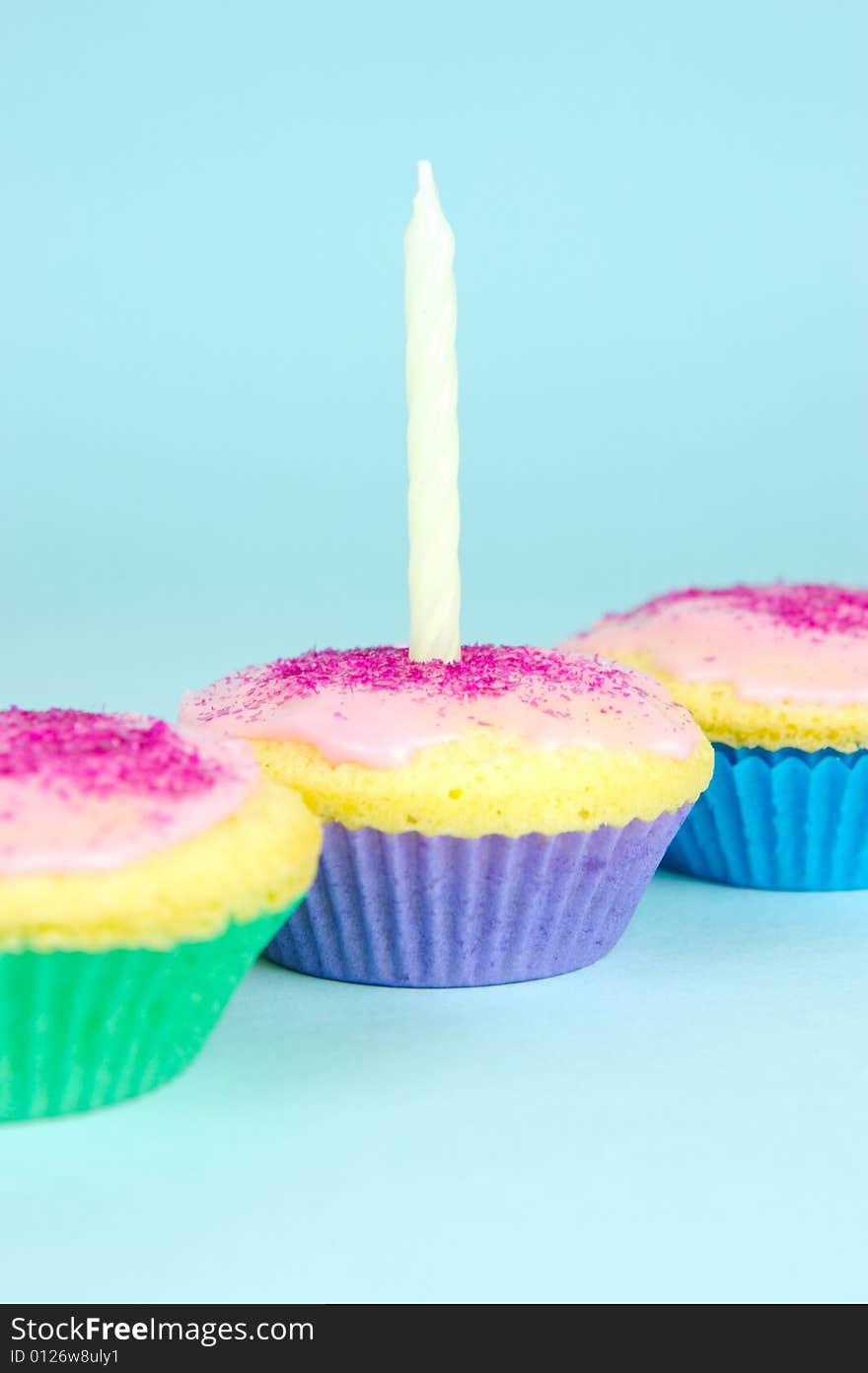 Cup cakes isolated against a blue background