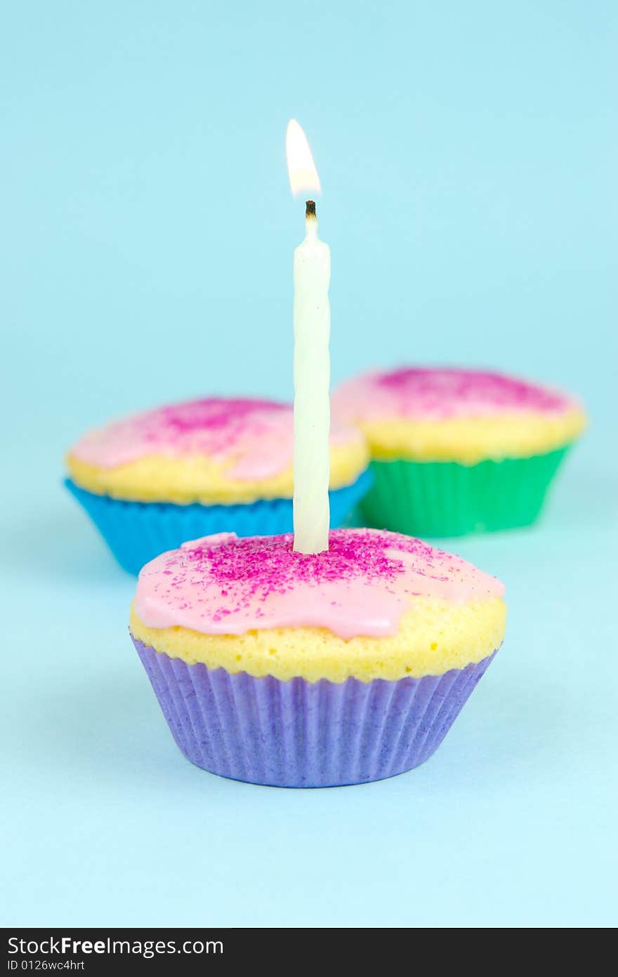 Cup cakes isolated against a blue background