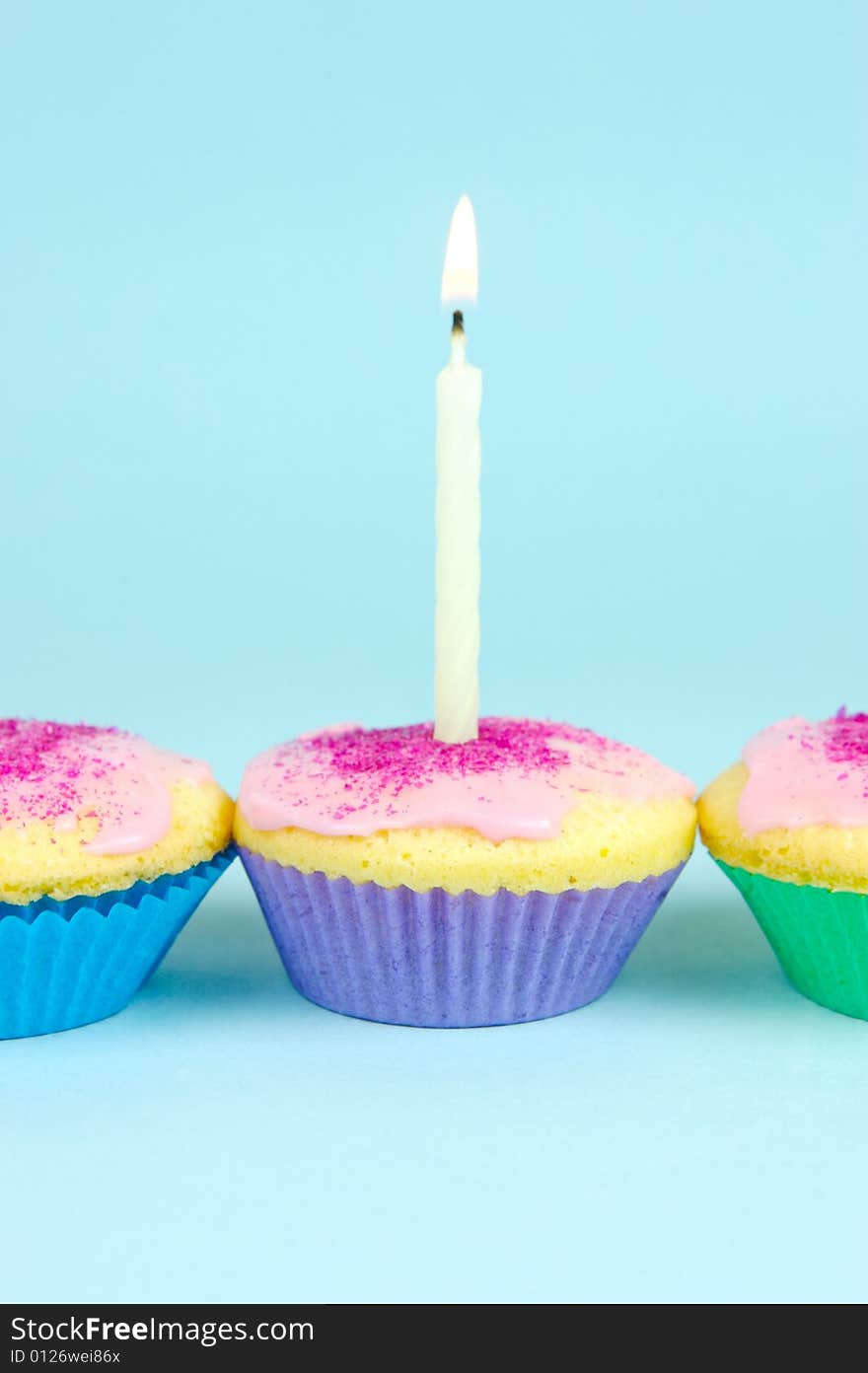 Cup cakes isolated against a blue background