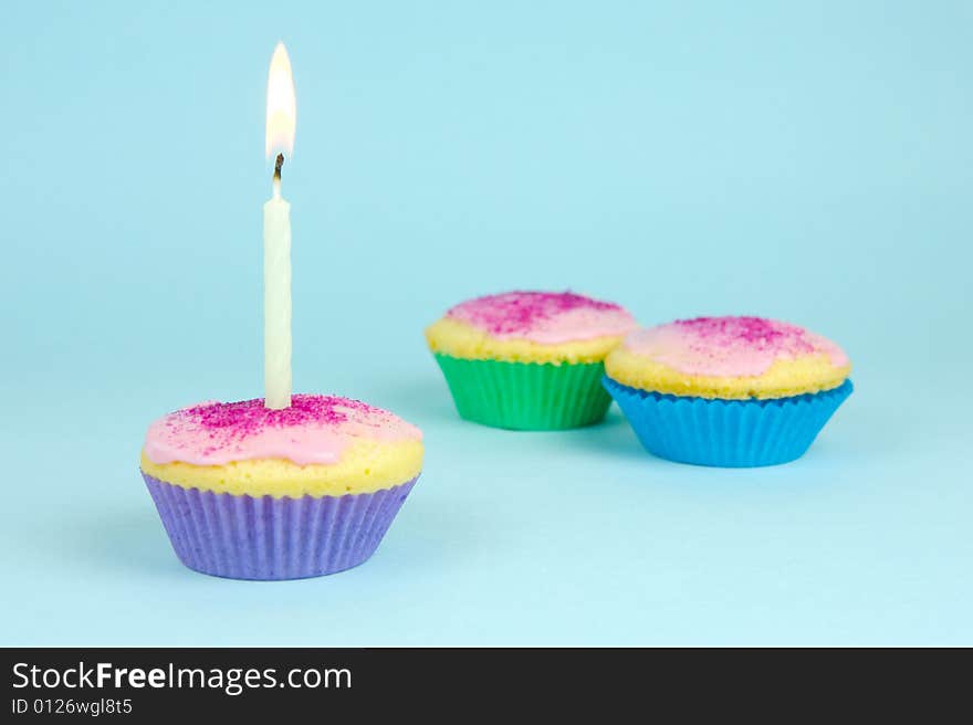 Cup cakes isolated against a blue background