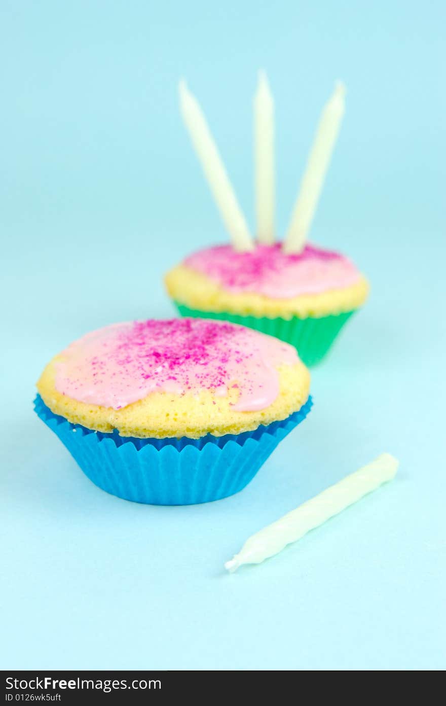 Cup cakes isolated against a blue background