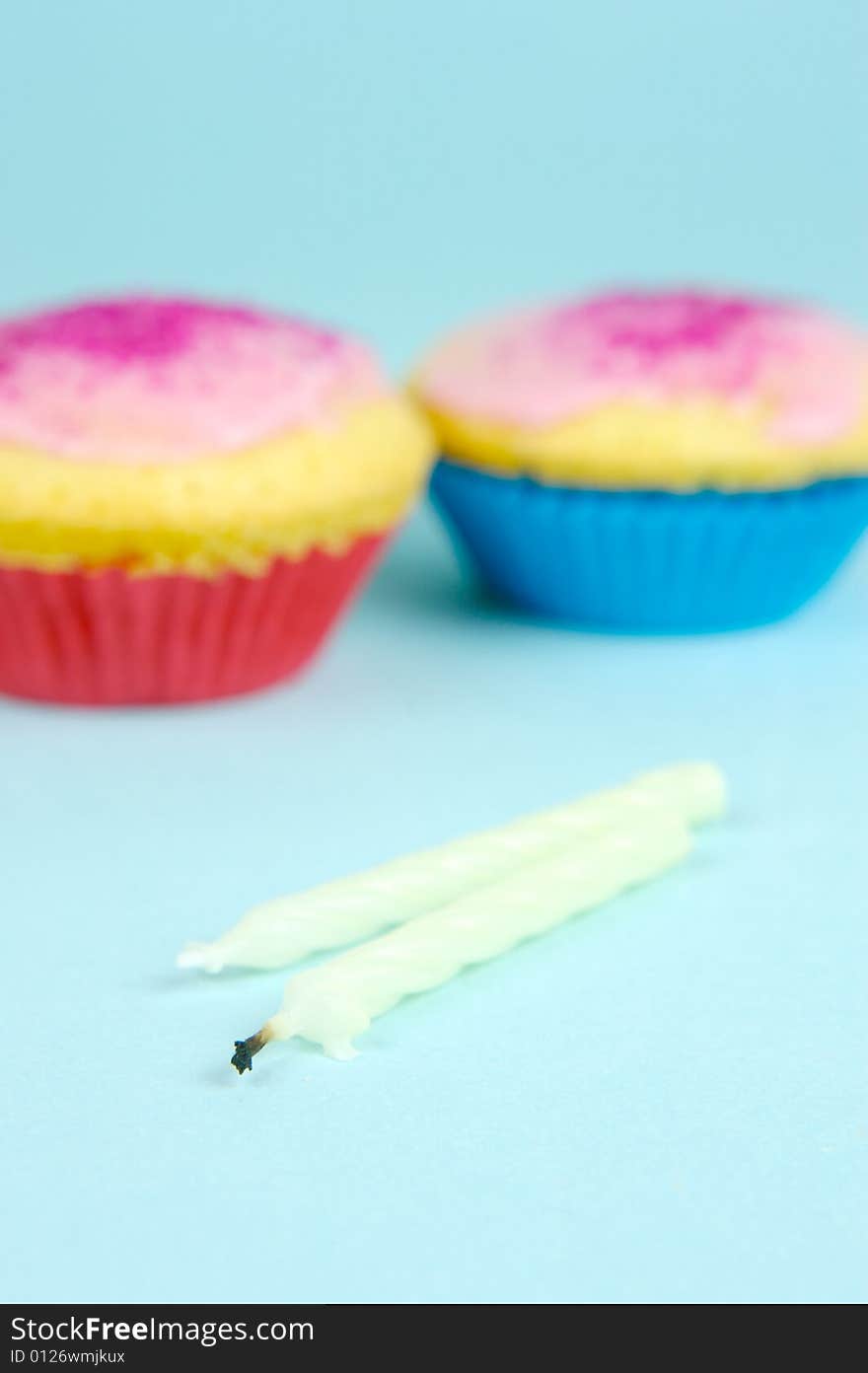 Cup cakes isolated against a blue background