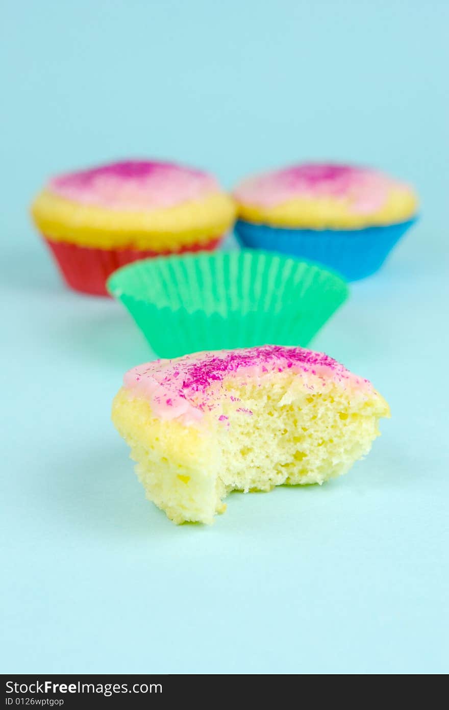 Cup cakes isolated against a blue background