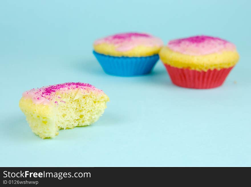 Cup cakes isolated against a blue background