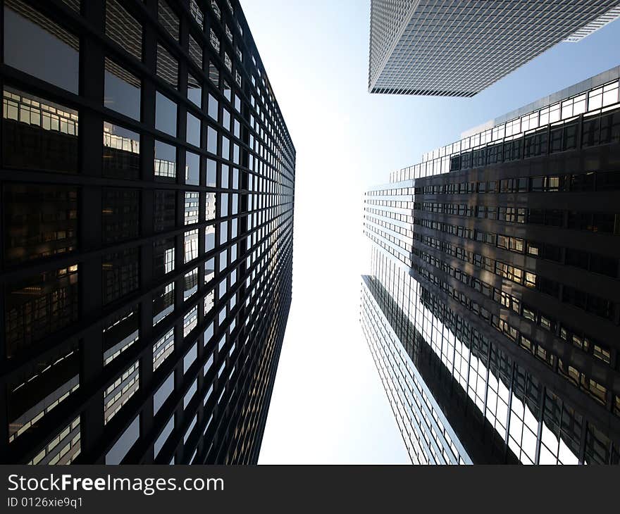 Looking up at tall skyscrapers