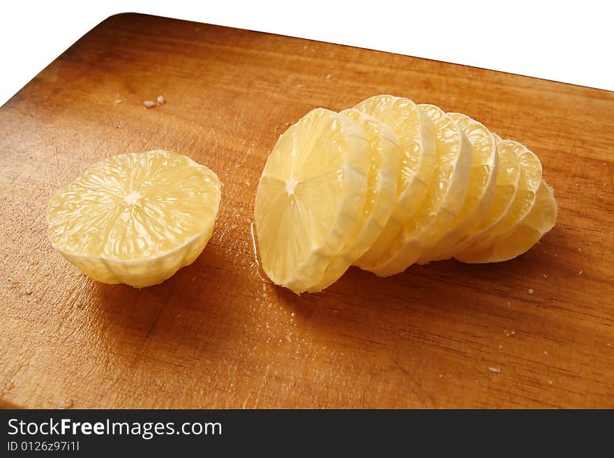 Sliced lemon on board isolated on white