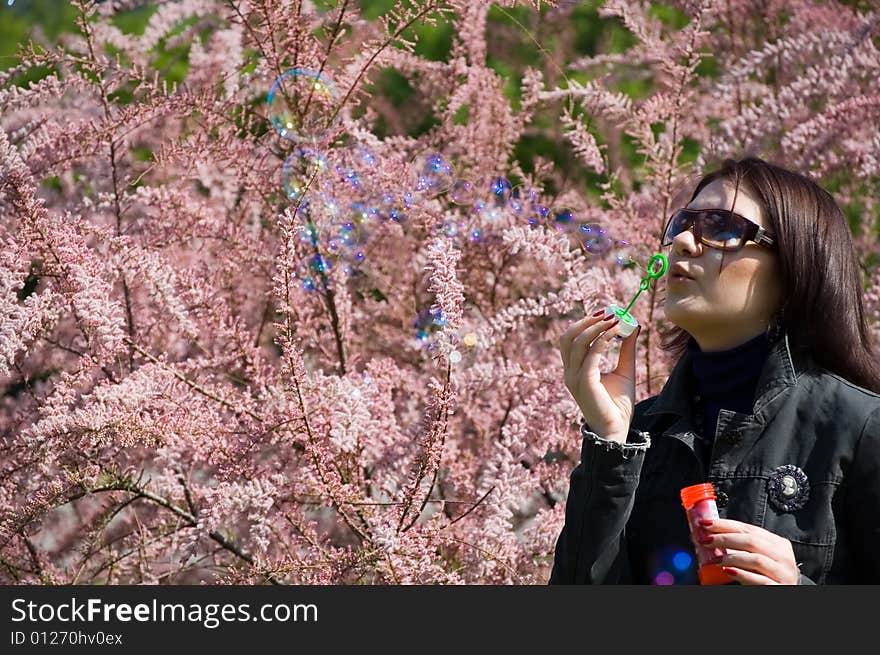 Girl blowing bubble in the park