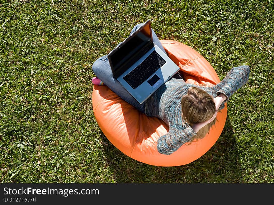 Beautiful woman working out sitting on orange puff