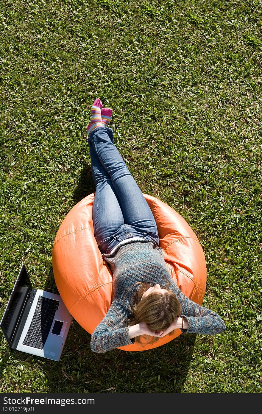 Beautiful woman working out sitting on orange puff